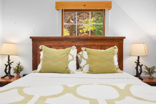 Reach over and turn off your own lamp — both sides get a nightstand, so nobody's climbing across anybody at midnight.