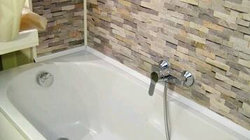 Bathtub, hair dryer, towels, soap