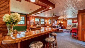 A wooden interior with a bar area, seating, and a staircase. - Ski season or yearly rental. Dogs loved! Walk to Equinox Pond & BBA. Fireplace (Manchester)