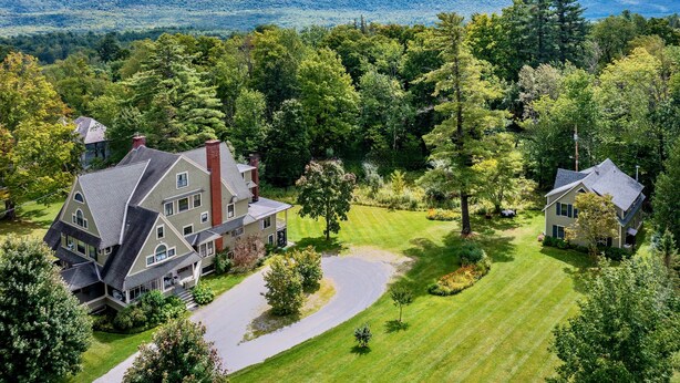 A large, two-story house with a wrap-around porch, surrounded by a well-maintained lawn and dense forest. - Ski season or yearly rental. Dogs loved! Walk to Equinox Pond & BBA. Fireplace (Manchester)