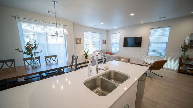 A modern kitchen with a large island, built-in appliances, and ample natural light from large windows.