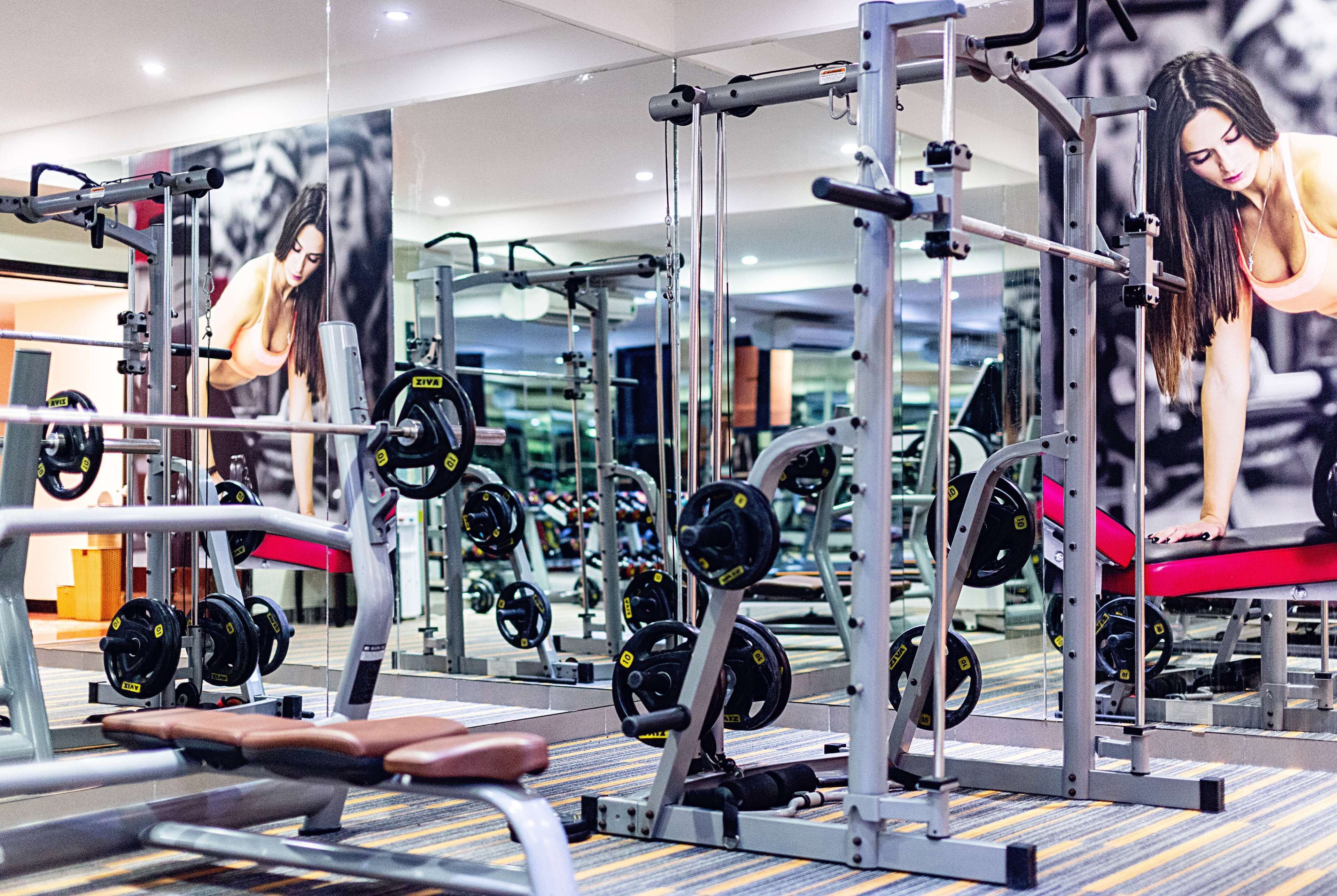 A gym with various exercise equipment, including weight machines and free weights.