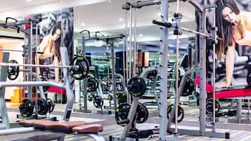 A gym with various exercise equipment, including weight machines and free weights.