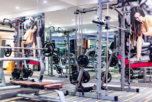 A gym with various exercise equipment, including weight machines and free weights.