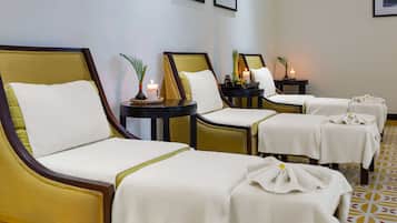 Relax in comfort with our spa-style massage chairs, each paired with a small table and a calming ambiance.