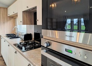 A modern kitchen with a built-in stove, a toaster, and a sink.