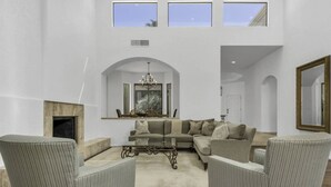 A spacious living room with a sectional sofa, two armchairs, a coffee table, and a fireplace. - Premium PGA West Location Large Saltwater Pool/Spa Fire Pit Spectacular Mtn Views: #067312 (La Quinta)