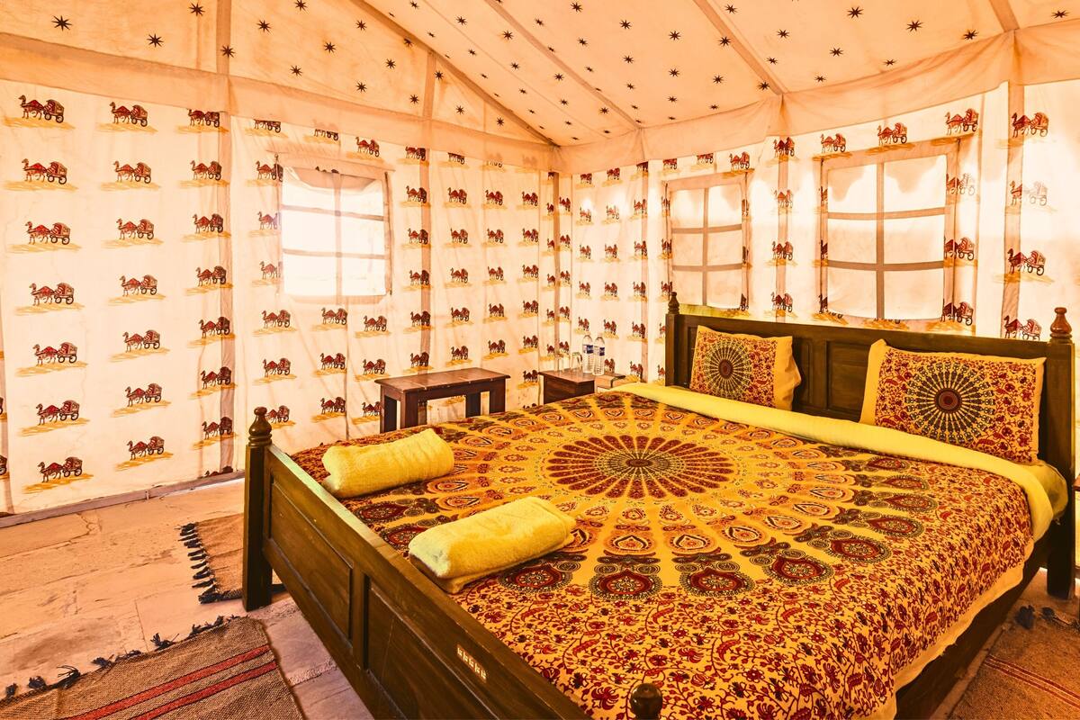 A room with a bed, a nightstand, and a window.