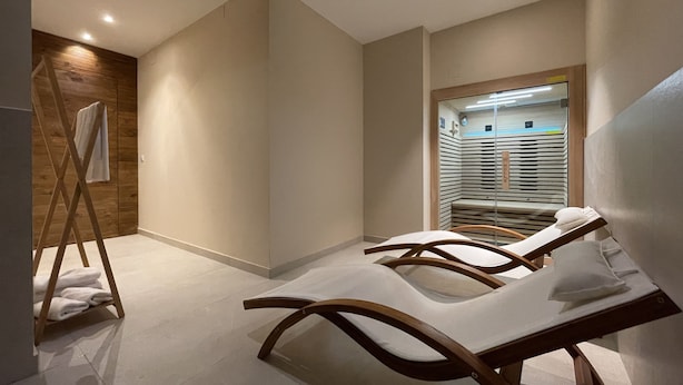 A modern bathroom with a wooden vanity, a towel rack, and a glass shower enclosure. - Apartamentos Las Indianas (Llanes)
