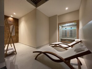 A modern bathroom with a wooden vanity, a towel rack, and a glass shower enclosure. - Apartamentos Las Indianas (Llanes)