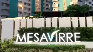 A high-rise residential building with multiple balconies and a sign reading "MESAVIRRE".