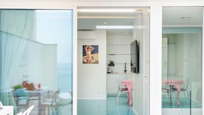 A modern interior with a dining area, a kitchen, and a living space.