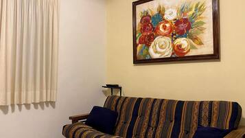 Departamento familiar, 2 habitaciones, balcón, vista a la playa | Área de sala de estar | Smart TV de 38 pulgadas con canales por cable y Netflix