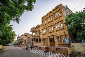 A historic building with ornate architecture, multiple floors, and a checkered pavement in front. - Hotel The Jaisal Classic Jaisalmer (Jaisalmer)