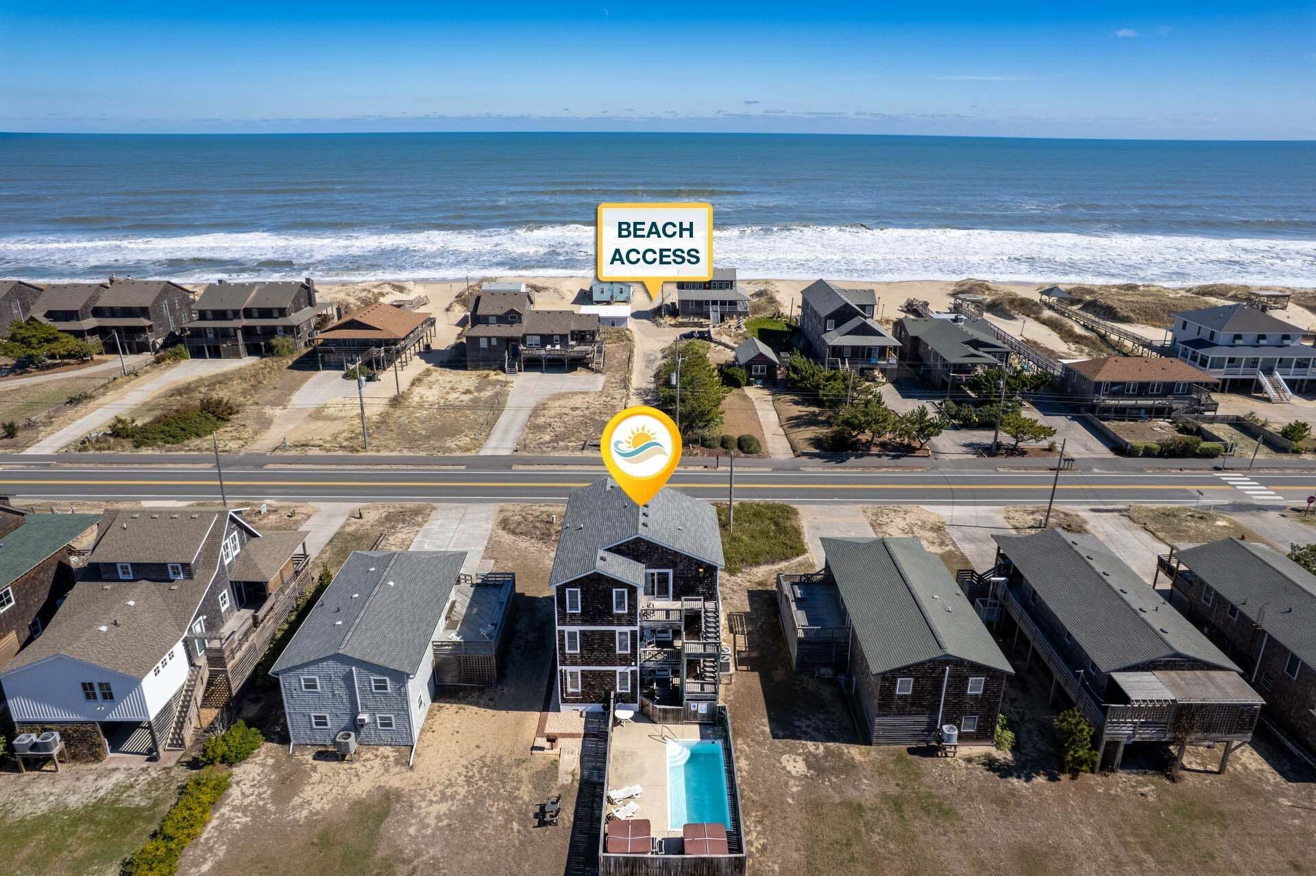 A residential area with beach access, houses, and a swimming pool.