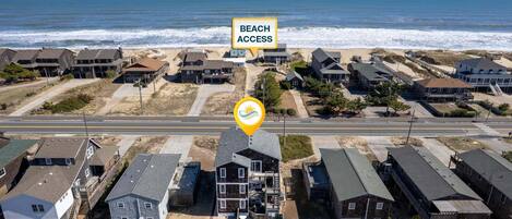 A residential area with beach access, houses, and a swimming pool.