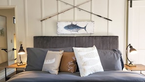 A bedroom with a bed, pillows, a headboard, and a wall-mounted artwork of a fish. - Fisherman's Delight in Waldport! Dog Friendly! Hot tub! (Waldport)