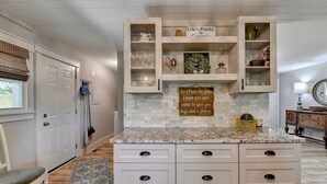 A kitchen with white cabinets, a marble countertop, and a decorative sign. - A Southern Retreat / Cozy Getaway in the heart of Atlanta Sleeps 4 (Atlanta)