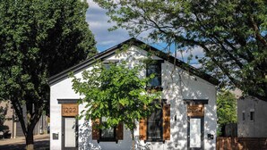 A white building with the number 1222 on the door, surrounded by trees. - Two Condos for 14 Guests, 5 Bedrooms, Free Parking (Covington)