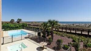 A rooftop pool with a view of the beach and ocean. - One Bedroom, One Bathroom Condo on the Oceanside (Carolina Beach)