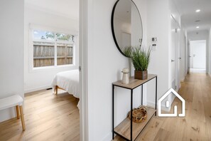 Enter a serene retreat with a large window offering a peaceful view of the outdoors.