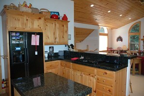 Fully equipped kitchen with a stove, microwave, and refrigerator.