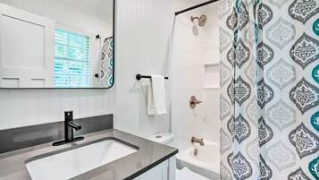 Combined shower/tub, hair dryer, towels, soap