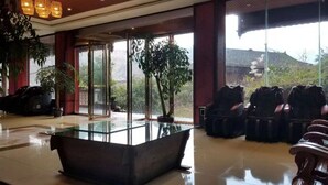 Un hall d’entrée spacieux, doté d’une table de billard au plateau en verre, de sièges confortables et de grandes fenêtres offrant une vue sur les environs.