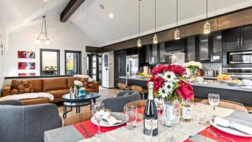 A modern kitchen with black cabinets, stainless steel appliances, and a central island.