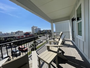 Enjoy the city view from this balcony with outdoor seating and a covered area.