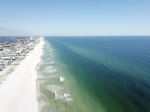 Guests enjoy beach access from our hotel's buildings, with the ocean visible to the right.