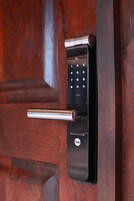 A Yale smart lock on a wooden door.