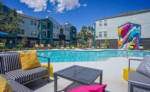 Relax by the pool surrounded by comfortable lounge chairs and a seating area.