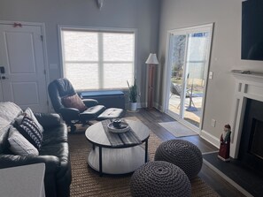 Smart TV, fireplace, books, computer monitors