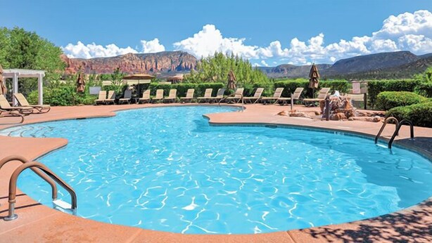 A swimming pool with lounge chairs and a view of mountains. - Sedona | Desert Golf Escape | Trails, Greens & Resort Pools (Sedona)