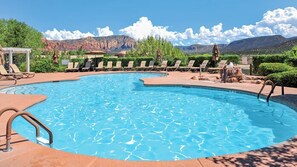 A swimming pool with lounge chairs and a view of mountains. - Sedona | Desert Golf Escape | Trails, Greens & Resort Pools (Sedona)