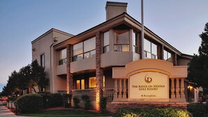 A two-story building with a sign reading "The Ridge on Sedona Golf Resort." - Sedona | Desert Golf Escape | Trails, Greens & Resort Pools (Sedona)