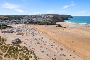 A beach with numerous tents and people.