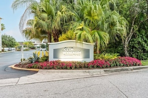 A Club Wyndham sign surrounded by lush greenery and a parking lot. - Orlando | Friends Orlando Getaway | 3BR Sleeps 8 (Orlando)