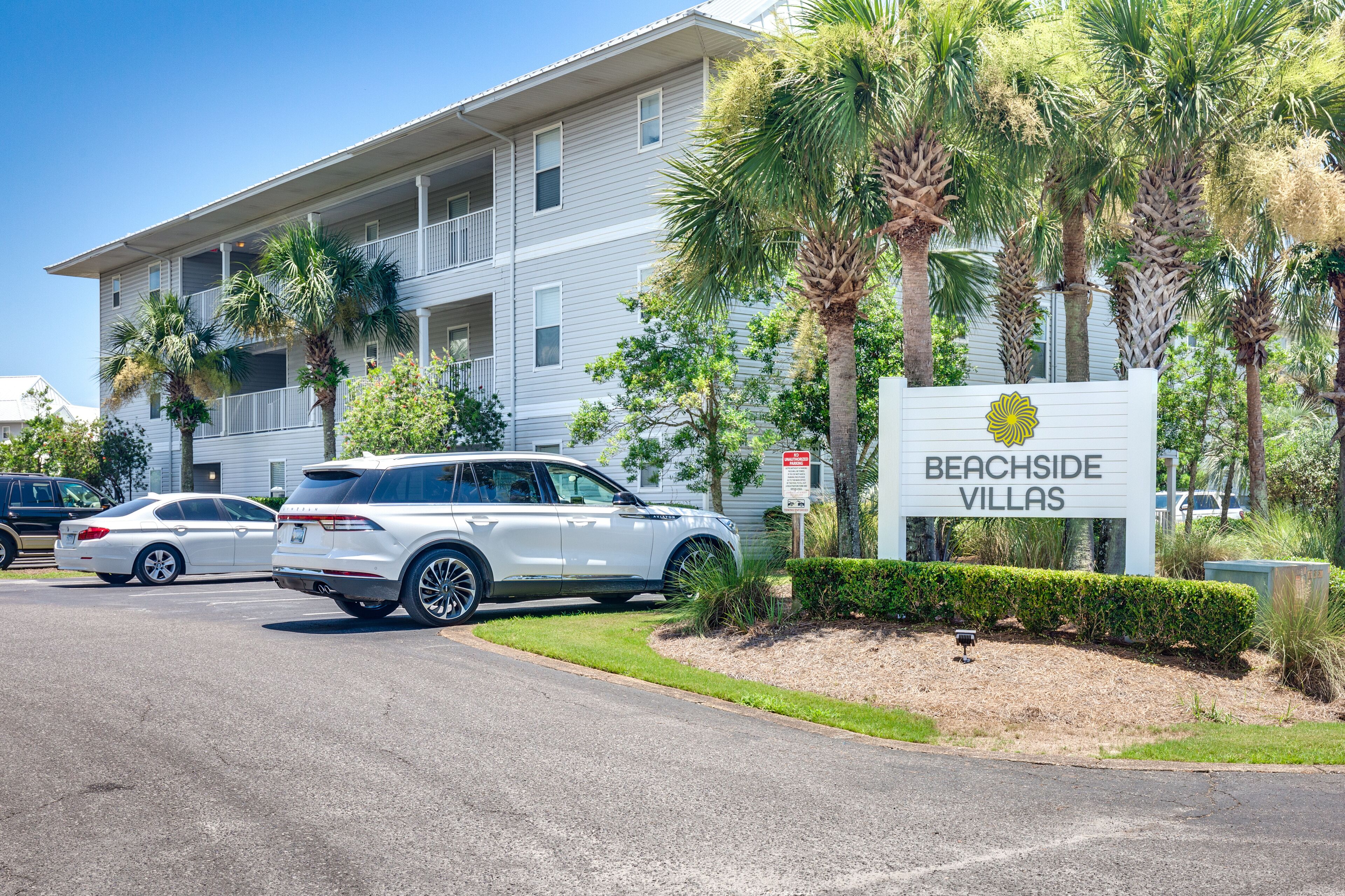 A multi-story building with a sign reading "Beachside Villas."