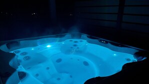 A hot tub with multiple jets, surrounded by a dark interior. - Hike Into RMNP From House-Coaster Passes-Hot Tub-King Bed-A/C-BBQ (Estes Park)