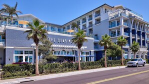 A multi-story hotel with a prominent sign reading "THE SEABIRD". - Oceanfront Gem: Dog-Friendly, AC, 2 Parking Spots, Walk to Pier & Shops (Oceanside)