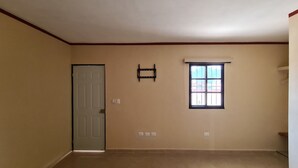 A room with a door, a window, and a wall-mounted shelf. - Hotel La Piramide Izamal (Izamal)