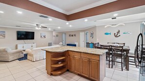 A spacious living area with a kitchen island, dining table, and seating. - Near Tesla's Building - Centralized location (St. Petersburg)