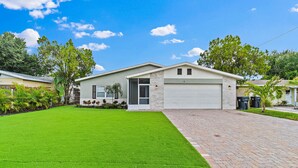 A two-story house with a garage, a well-maintained lawn, and a brick driveway. - Near Tesla's Building - Centralized location (St. Petersburg)