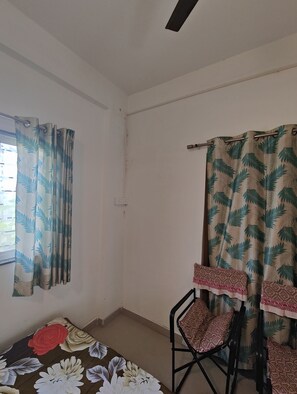 Relax in this serene space with a window offering a view, a table for dining, and a comfortable chair.