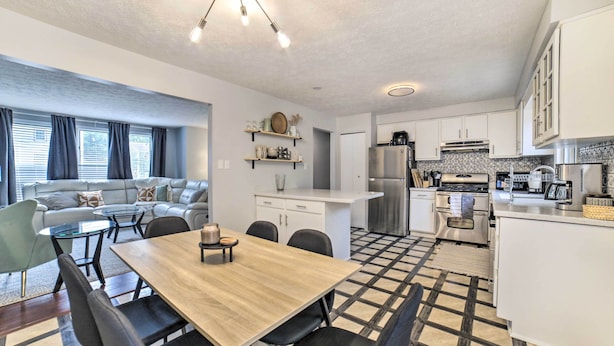 A modern kitchen with white cabinets, a stainless steel refrigerator, and a coffee maker. - Pittsburgh Retreat w/ Deck ~ 4 Mi to Dtwn! (Pittsburgh)