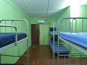 Cozy retreat with two bunk beds and a door to an adjoining space.