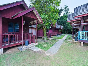 Houses line a quiet pathway, each with a charming porch and comfortable seating.