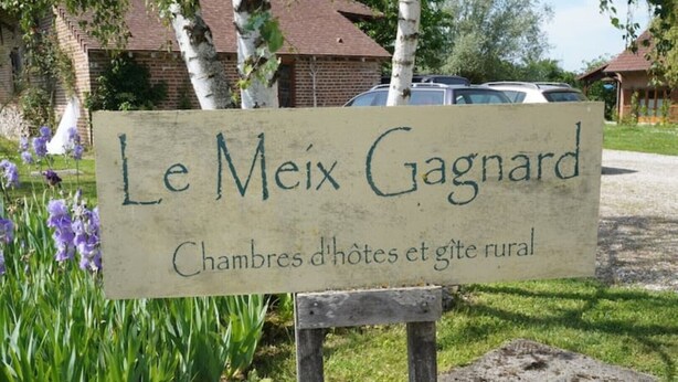 En skylt med texten ”Le Meix Gagnard” som visar att det är ett lantligt pensionat med rum och en trädgård.